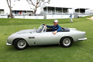 Padraig Harrington drives a miniature Aston Martin after the 2024 Hoag Classic Newport Beach