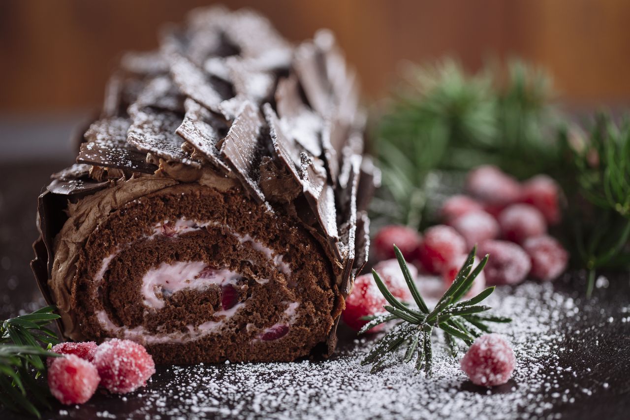 Close up picture of a black forest roulade decorated with chocolate bark