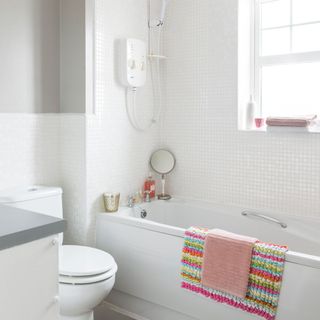 bathroom with white wall and window