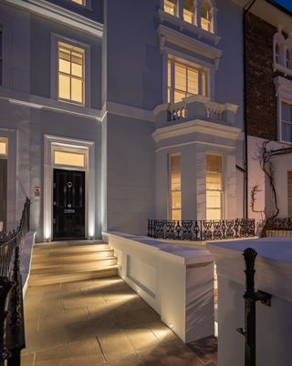steps to black front door with lighting
