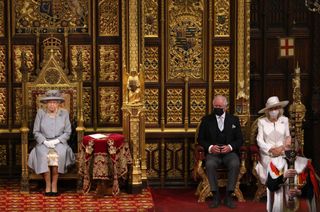 Queen Elizabeth II sits on the The Sovereign's Throne in the House of Lords chamber, with Prince Charles, Prince of Wales and Camilla, Duchess of Cornwall.