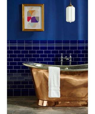 Blue tiled bathroom with freestanding bath by Original Style