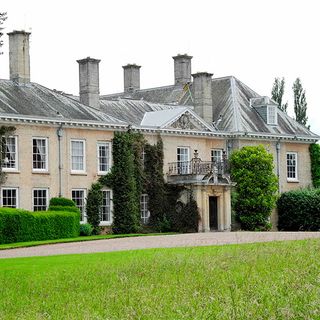 house exterior with lawn and green grass