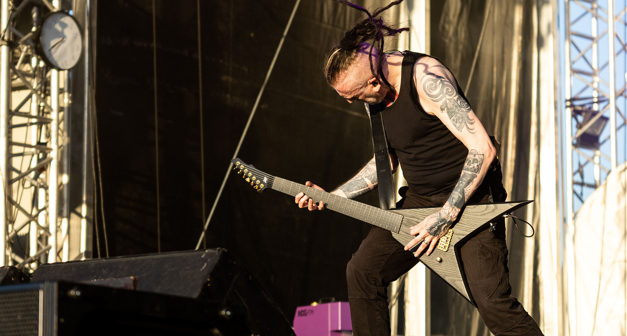 Greg Mackintosh of Paradise Lost headbangs as he performs an afternoon festival show. He plays his custom Hapas V.