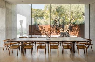 Dining area that connects to the outdoors through large glazing at Austin house by Studio DuBois and Elizabeth Stanley design.