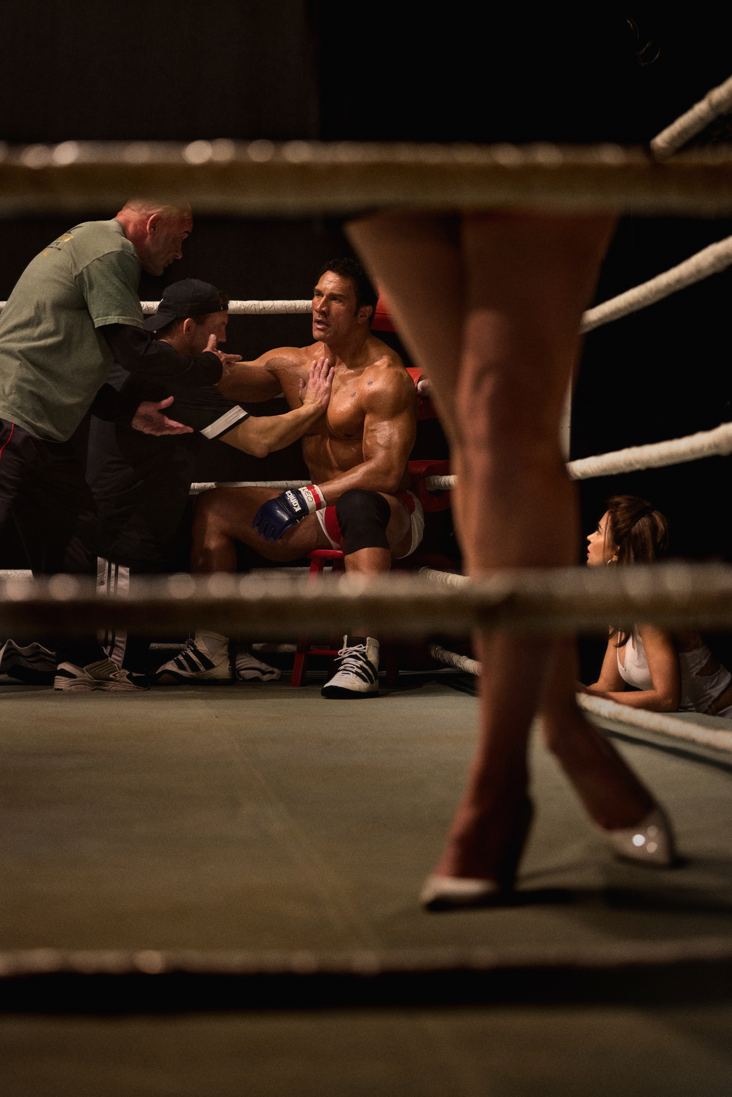 dwayne the rock johnson as ufc fighter matt kerr sitting in a ring in a still from the movie the smashing machine