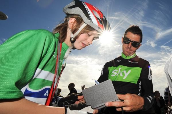 Team Sky's Russell Downing signs autographs before the final stage start.