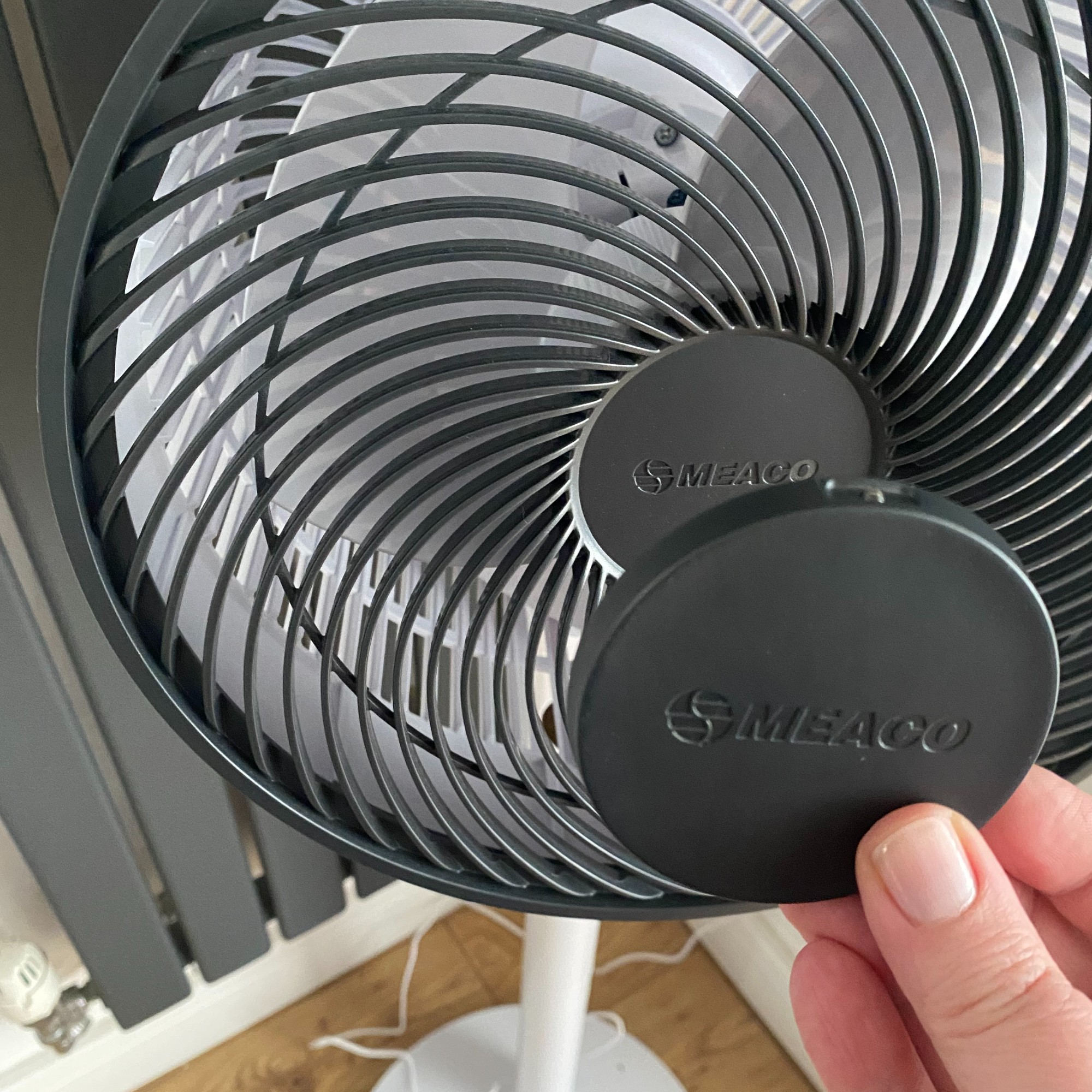 Showing how the remote of the Meaco MeacoFan Sefte 10'' pedestal air circulator fan attaches magnetically to the fan