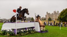 Tom Bird and Cowling Hot Gossip jump Lambert&rsquo;s Sofa at Burghley 2024 with Burghley House in the background.