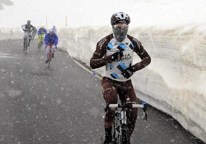 An Ag2r-La Mondiale rider wraps up and tries to keep warm on the Stelvio