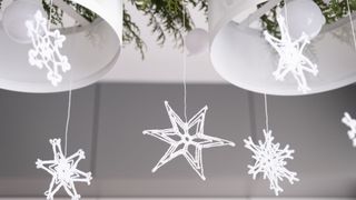 knitted snowflake decorations hanging from ceiling