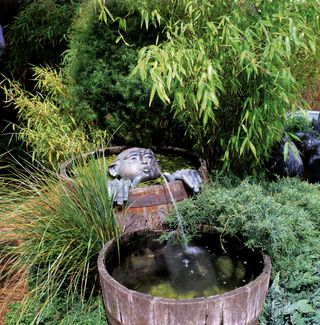 wooden barrel ponds with sculpture