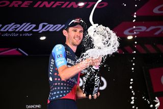 Derek Gee celebrates winning the combativity award at the end of the 2023 Giro d'Italia