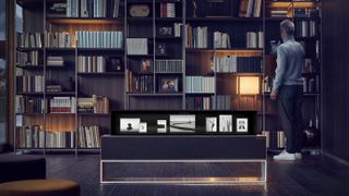 rollable OLED TV in rolled-up position, in front of bookshelf