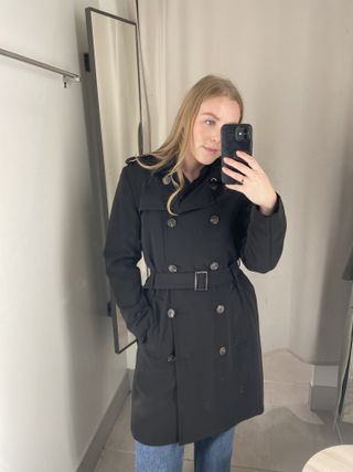 Woman wears black H&M trench coat