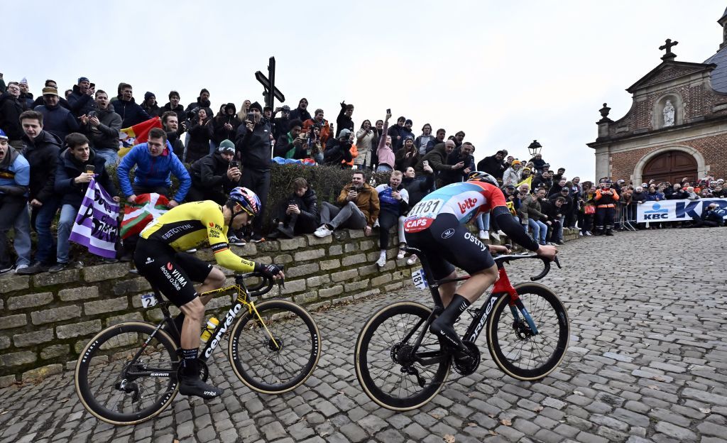 Belgian Wout van Aert of Team Visma-Lease a Bike and Belgian Arnaud De Lie of Lotto Dstny on the Kapelmuur during the 79th edition of the men's one-day cycling race Omloop Het Nieuwsblad (UCI World Tour), 202km from Gent to Ninove, Saturday 24 February 2024. BELGA PHOTO DIRK WAEM (Photo by DIRK WAEM / BELGA MAG / Belga via AFP)