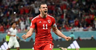 Gareth Bale of Wales celebrates with teammates after scoring their team's first goal via a penalty past Matt Turner of United States during the FIFA World Cup Qatar 2022 Group B match between USA and Wales at Ahmad Bin Ali Stadium on November 21, 2022 in Doha, Qatar.