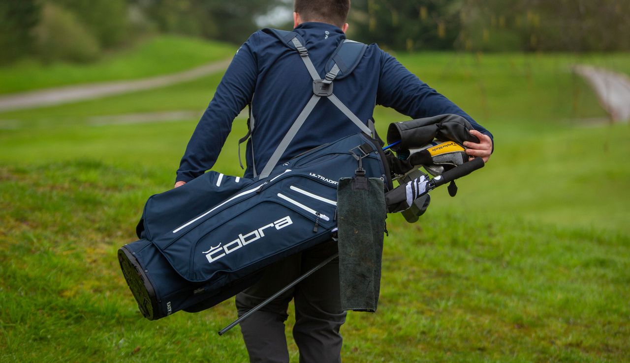 The Cobra Ultradry Pro 2023 Stand Bag on the back of the golfer
