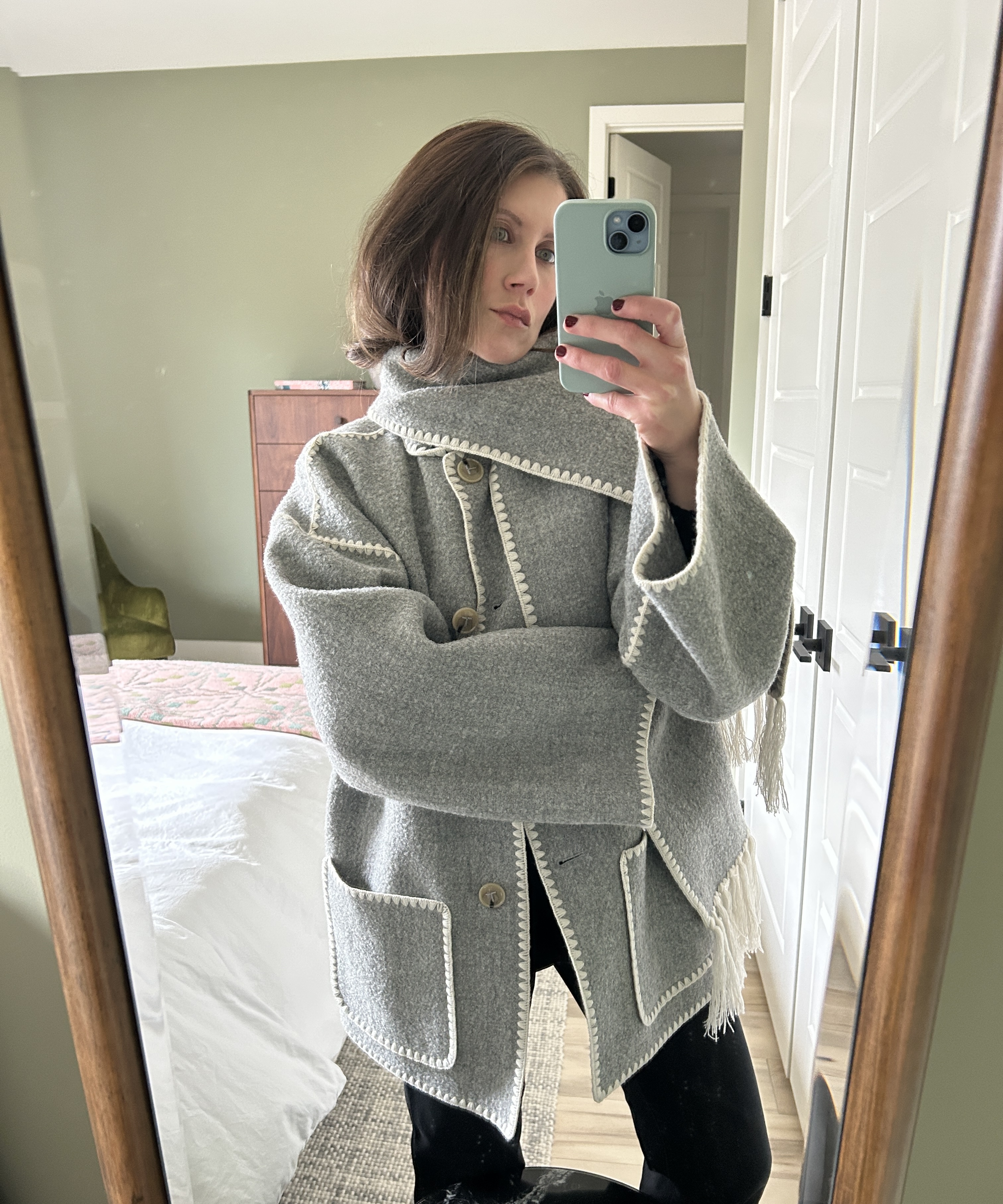 Senior fashion editor Ally Payer wearing a gray Toteme scarf coat.