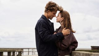 Chris Olsen (Christian Fandango) and Stella (Alexandra Tyrefors) looking into each other's eyes on a pier in A Nearly Normal Family