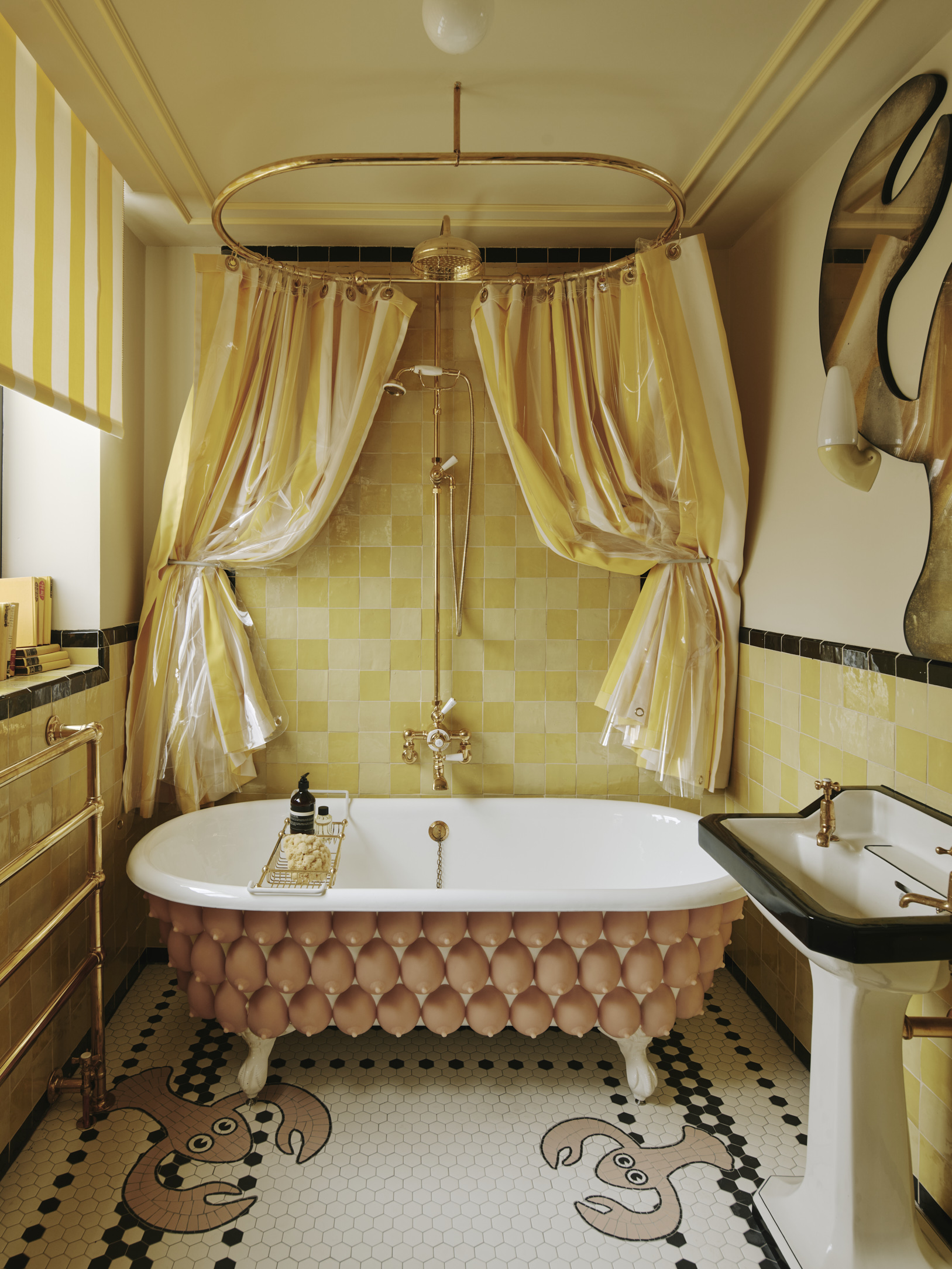 A bathtub covered in 108 silicone breasts basking in the glow of a yellow-tiled bathroom.