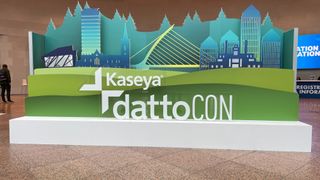 A sign in a conference hall lobby showing the logo for Kaseya DattoCon Europe 2023