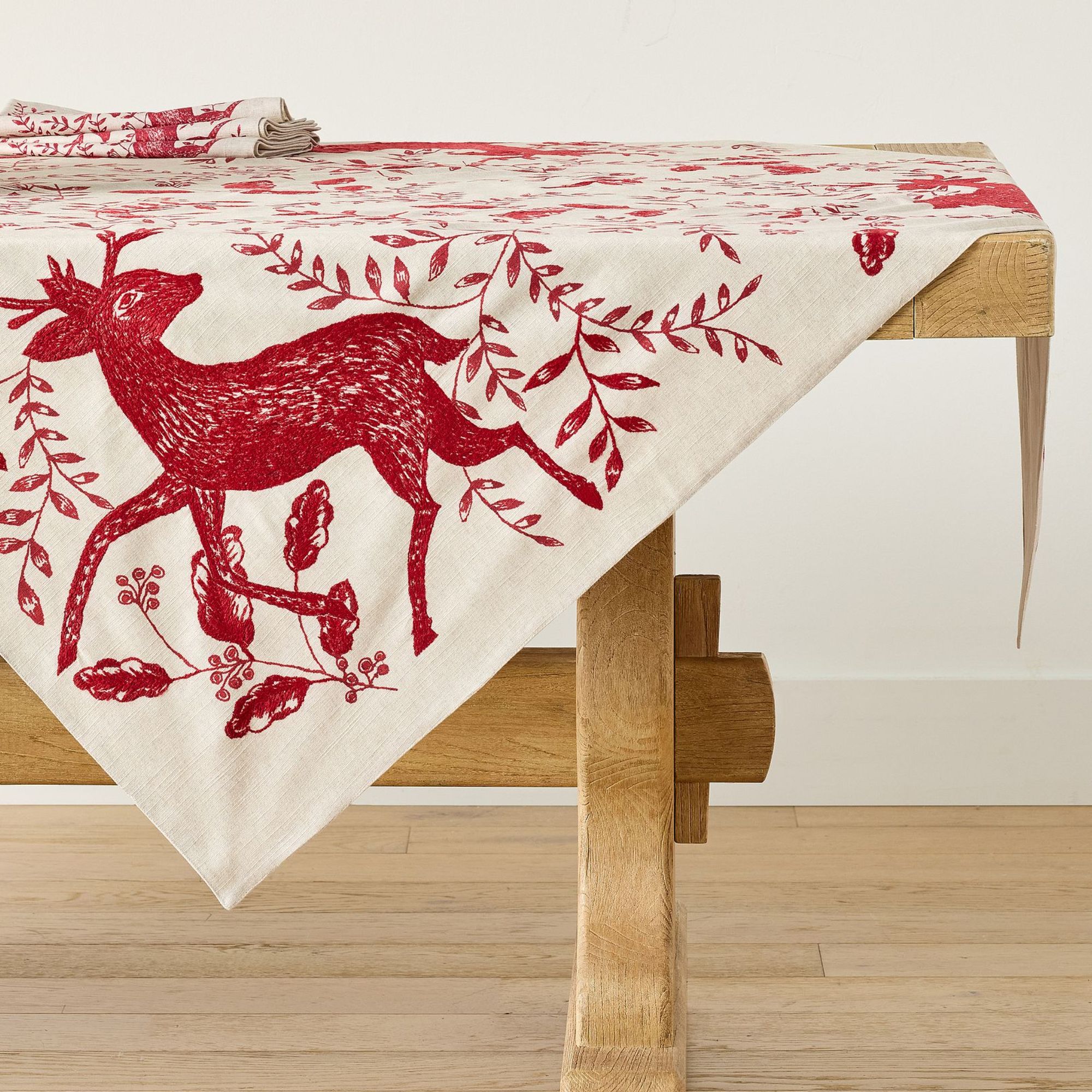 White table throw with red deer motifs
