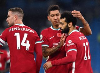 Liverpool’s Mohamed Salah (right) celebrates scoring his side’s first goal of the game from the penalty spot with Roberto Firmino during the Premier League match at the Etihad Stadium, Manchester