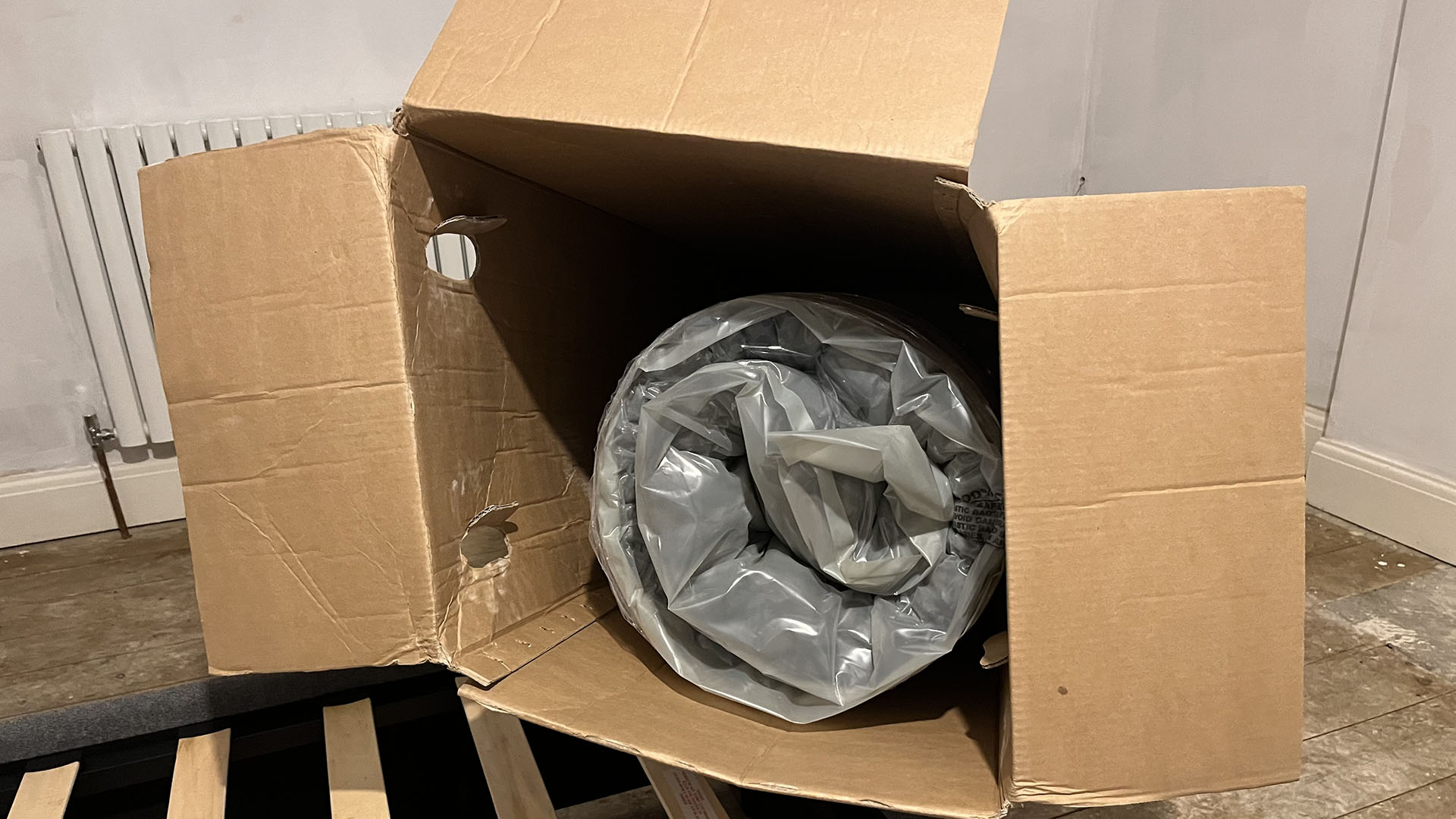 Zoma Hybrid mattress vacuum-packed and rolled in its box