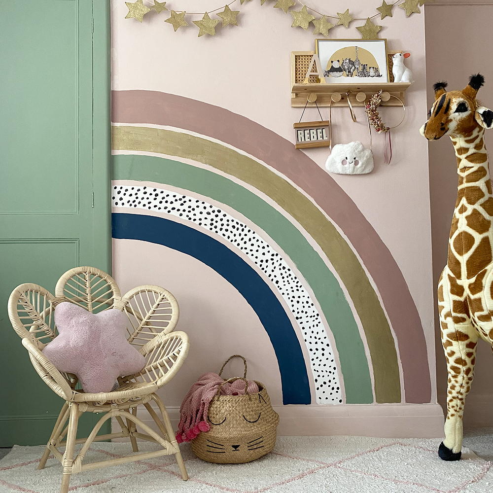 room with giraffe toy and rainbow printed wall