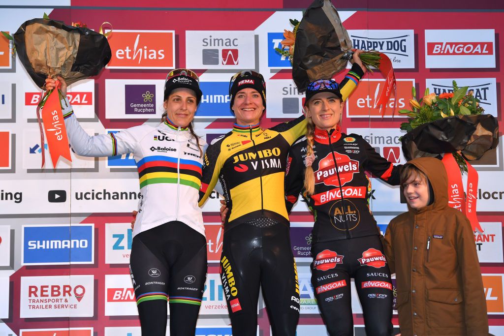 RUCPHEN NETHERLANDS DECEMBER 18 LR Lucinda Brand of The Netherlands and Team Baloise Trek Lions on second place race winner Marianne Vos of The Netherlands and JumboVisma Women Team and Denise Betsema of The Netherlands and Team Pauwels Sauzen Bingoal on third place pose on the podium ceremony after the 9th Rucphen UCI CycloCross Worldcup 2021 Womens Elite CXWorldCup UCIcyclocrossWC on December 18 2021 in Rucphen Netherlands Photo by Luc ClaessenGetty Images