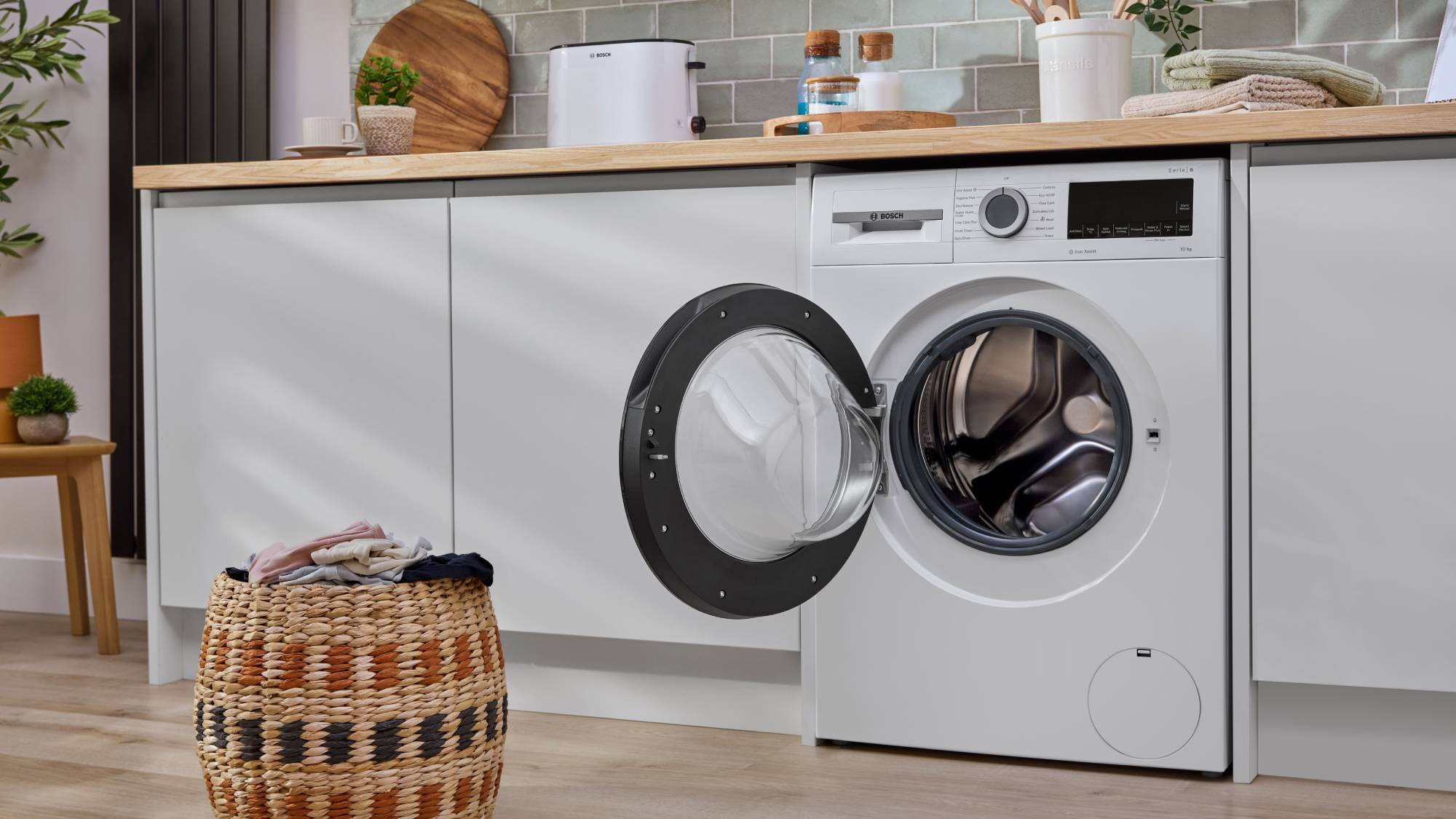 Bosch freestanding washing machine in run of white cabinets