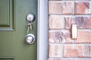 Green front door with house keys
