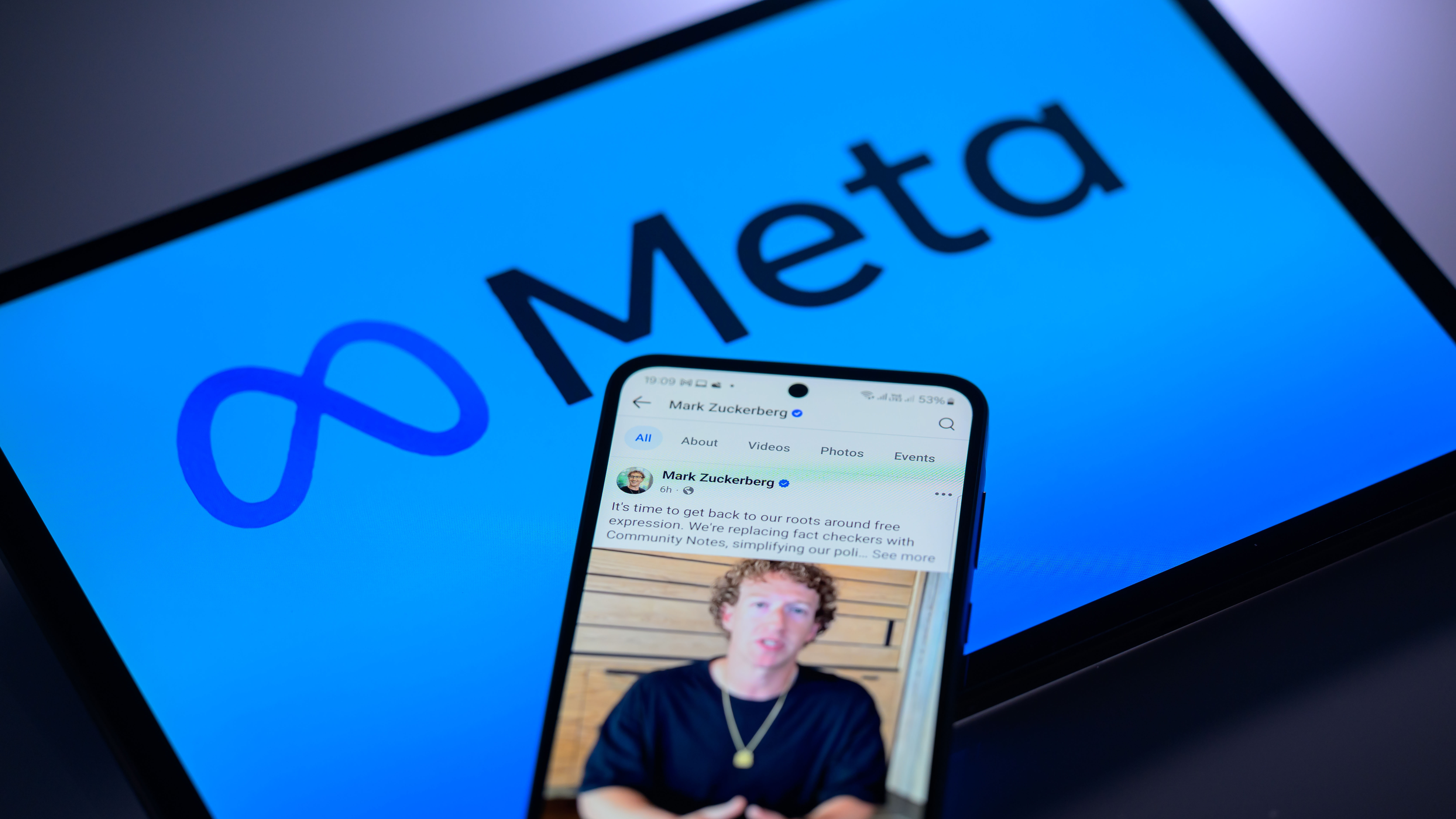 Mark Zuckerberg's personal Facebook account is displayed on a mobile phone with the Meta logo visible on a tablet screen in this photo illustration in Brussels, Belgium, on January 7, 2025.