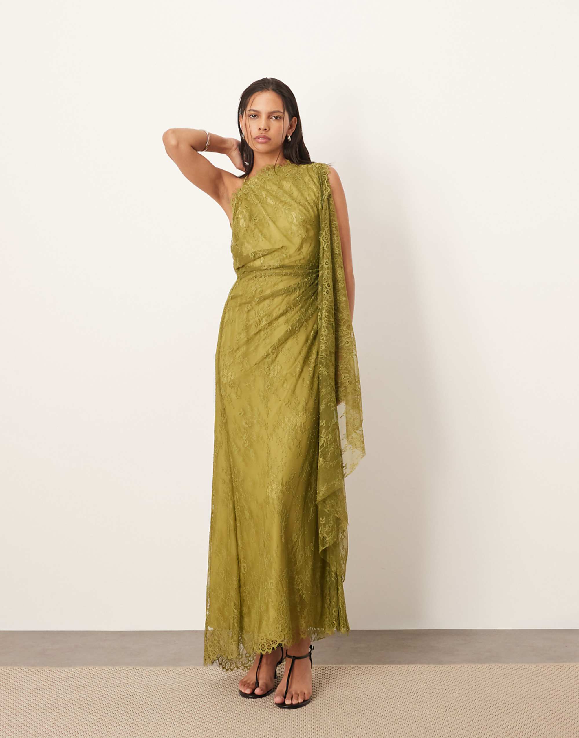 Arrange backless lace shawl dress with scallops among olives
