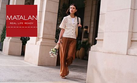 Woman wearing Matalan's blouse and pants holding flowers