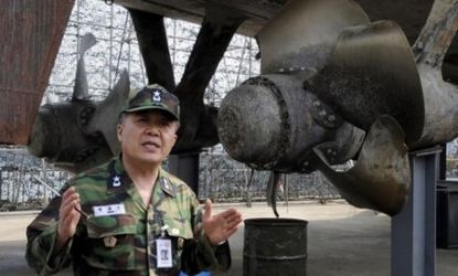 Suth Korean Navy admiral Park Jung-Soo speaks in front of the wreckage of the Cheonan.