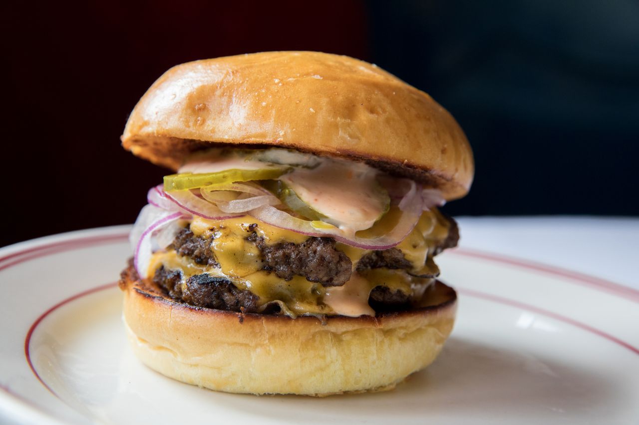 A cheeseburger on a plate.