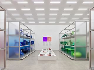 Colourful furniture on shelves, part of Vitra Colour Rush! installation