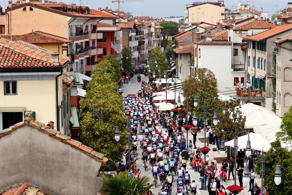 Cyclists take the start of the 15th stage of the Giro dItalia 2021 cycling race a 147km race between Grado and Gorizia on May 23 2021 Photo by Luca Bettini AFP Photo by LUCA BETTINIAFP via Getty Images