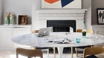 a laptop on a dining table