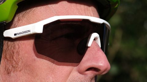 Close up of a man wearing Madison cycling sunglasses