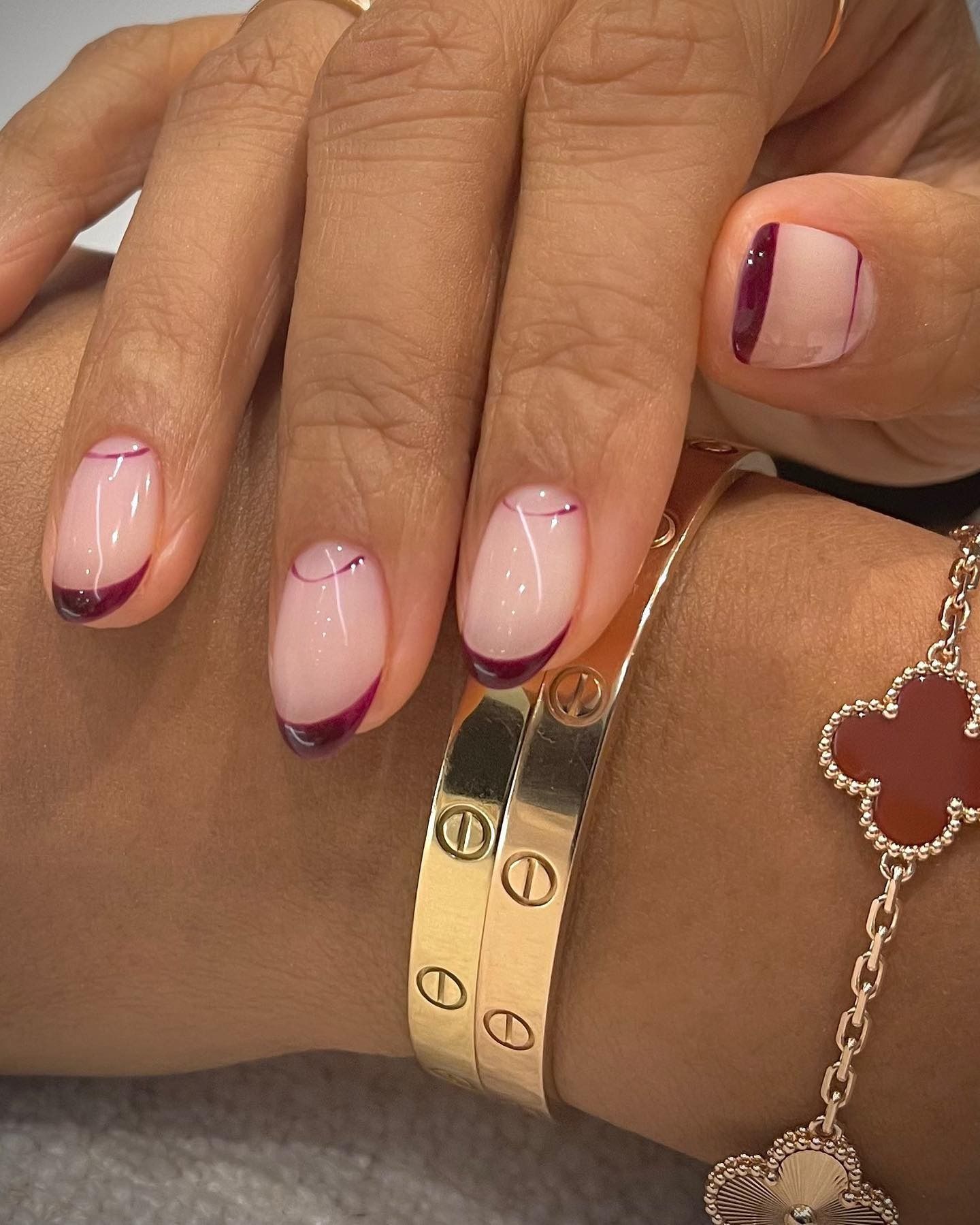 A burgundy double French tip nail design