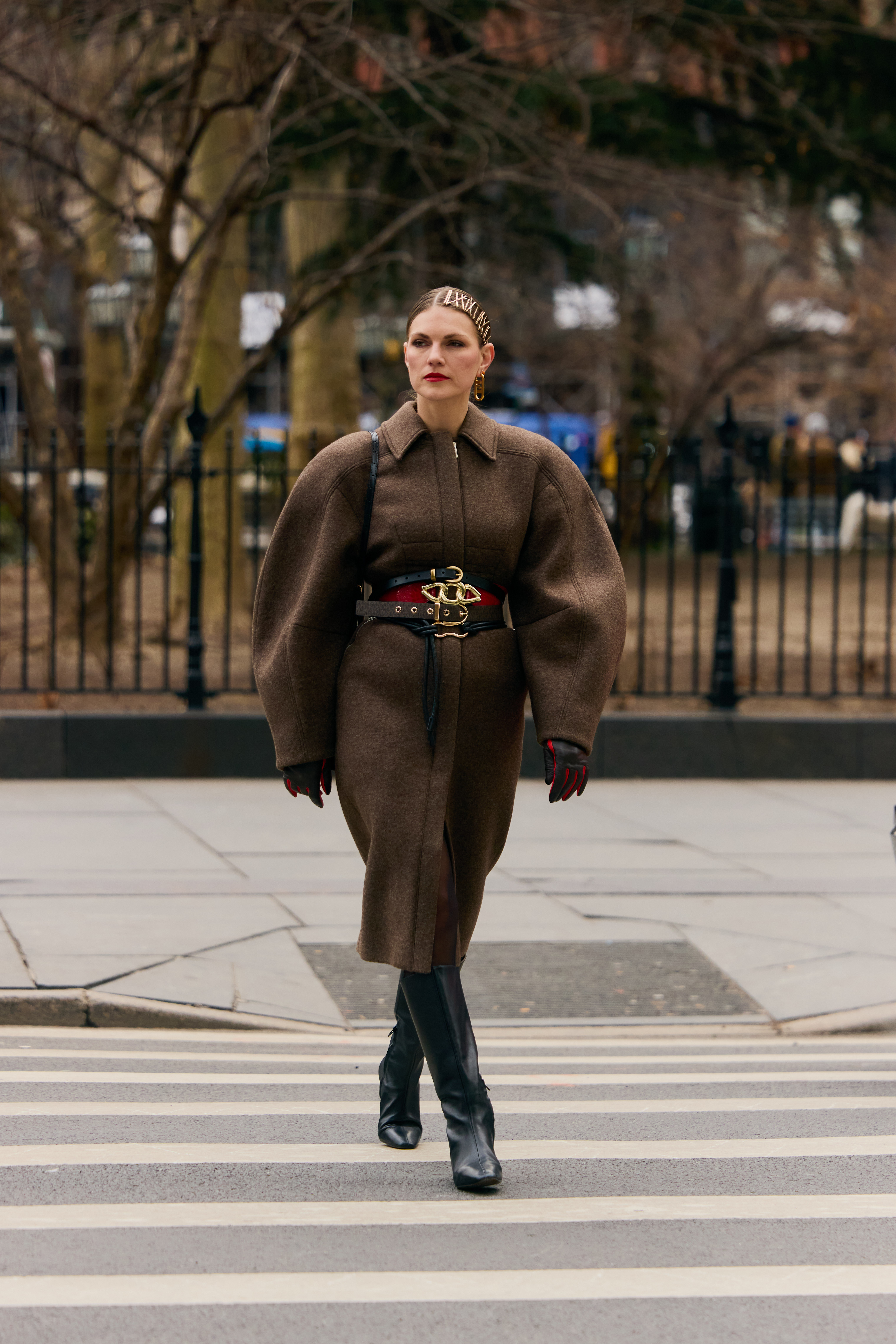 New York Fashion Week attendee wears layered belts.