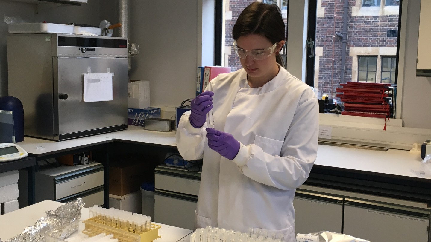 Bioarchaeologist Sam Leggett analyzes samples in the lab.