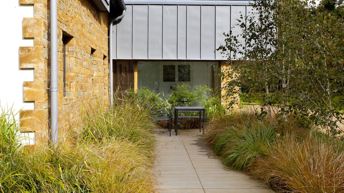 concrete path with planted edging towards a seating area