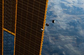 Several tiny satellites float in front of the ISS in this image by an Expedition 33 crew member from the International Space Station. This image was taken Oct.4, 2012.