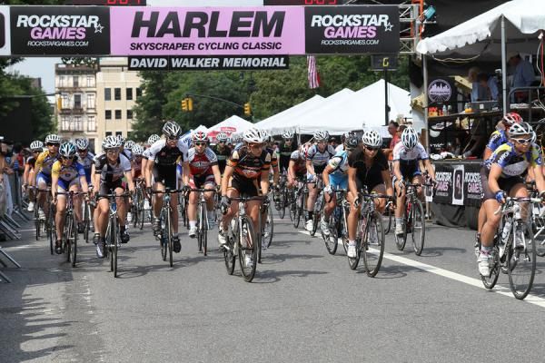 Under a sunny sky the women take off from a packed start line.