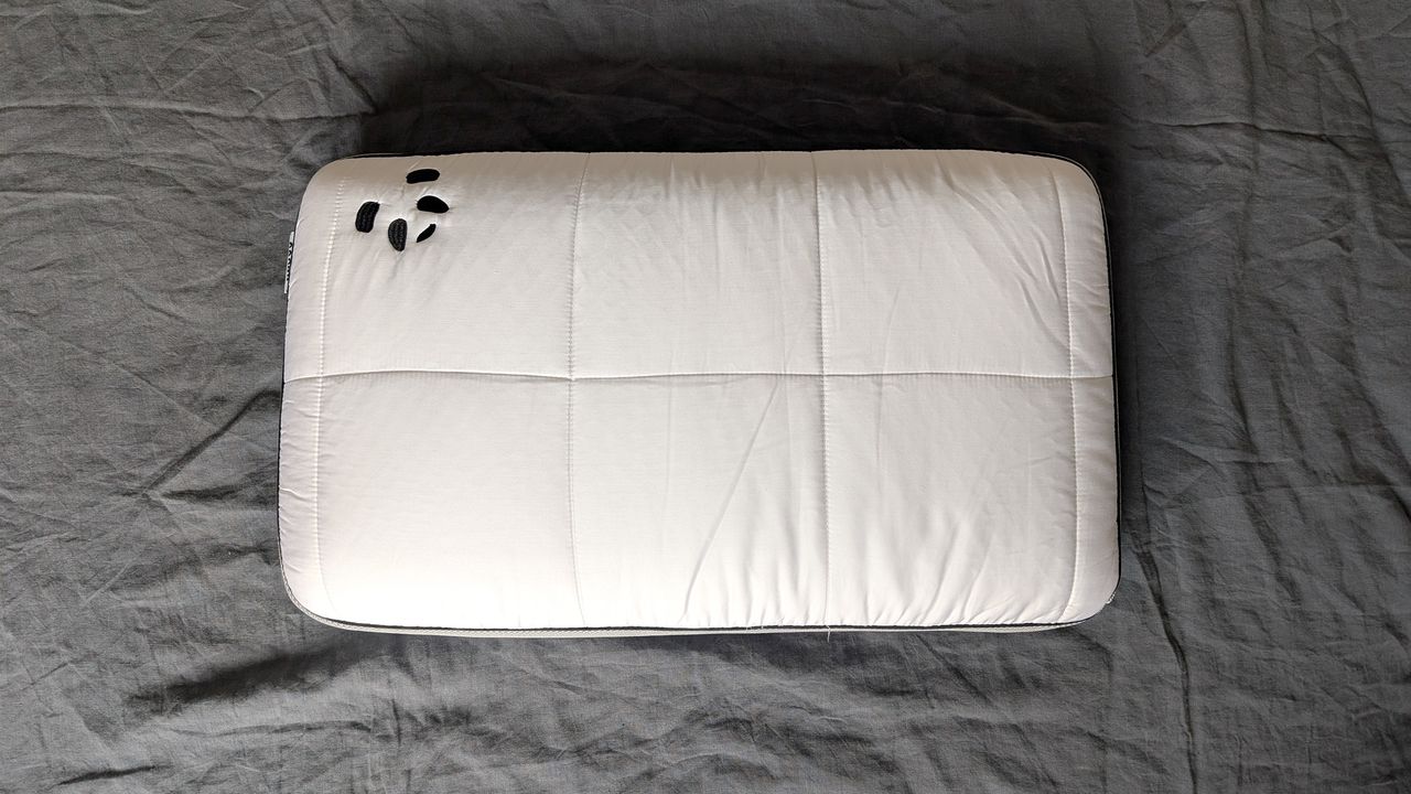 The Panda Hybrid Bamboo Pillow being tested on a grey linen duvet cover