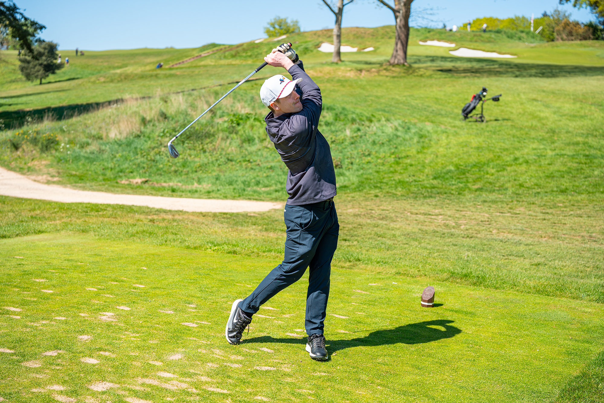 Jonny Leighfield, Golf Monthly News Writer, in the finish position with an iron after hitting a tee shot on a par-3 at Tandridge Golf Club